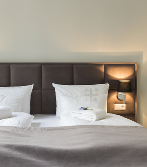 Hotelbett mit Jerusalemkreuz