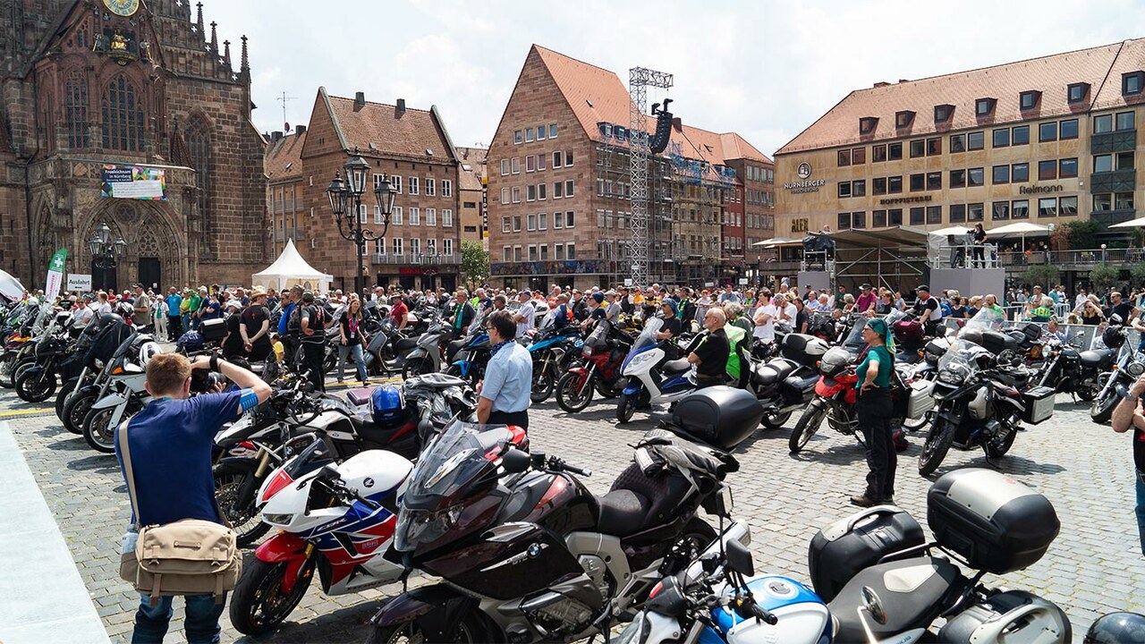 Kirchplatz voller Motorräder bei schönem Wetter
